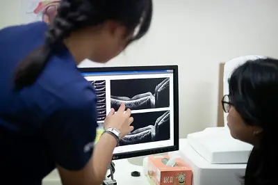 Optometry student working on an optical coherence tomography